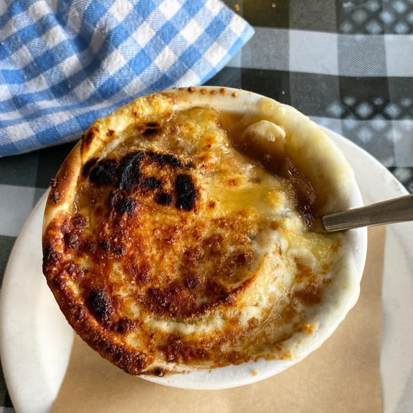 A bowl of French onion soup with melted, bubbly cheese on top, served at The Kettle diner.