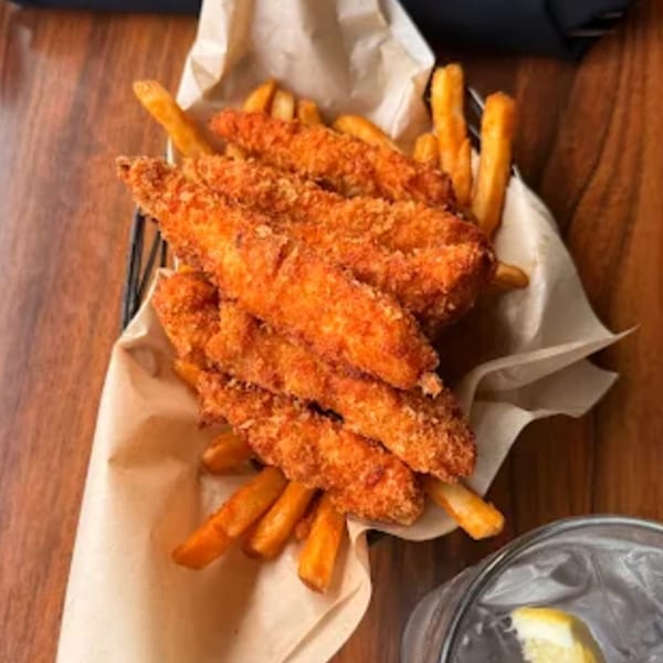 A basket of crispy chicken tenders and golden french fries from The Kettle diner.